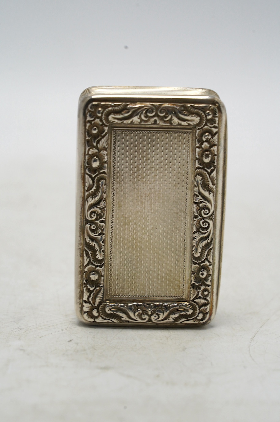 A late George III engine turned silver snuff box, William Elliot, London, 1819, 74mm, with interior engraved inscription. Condition - fair to good